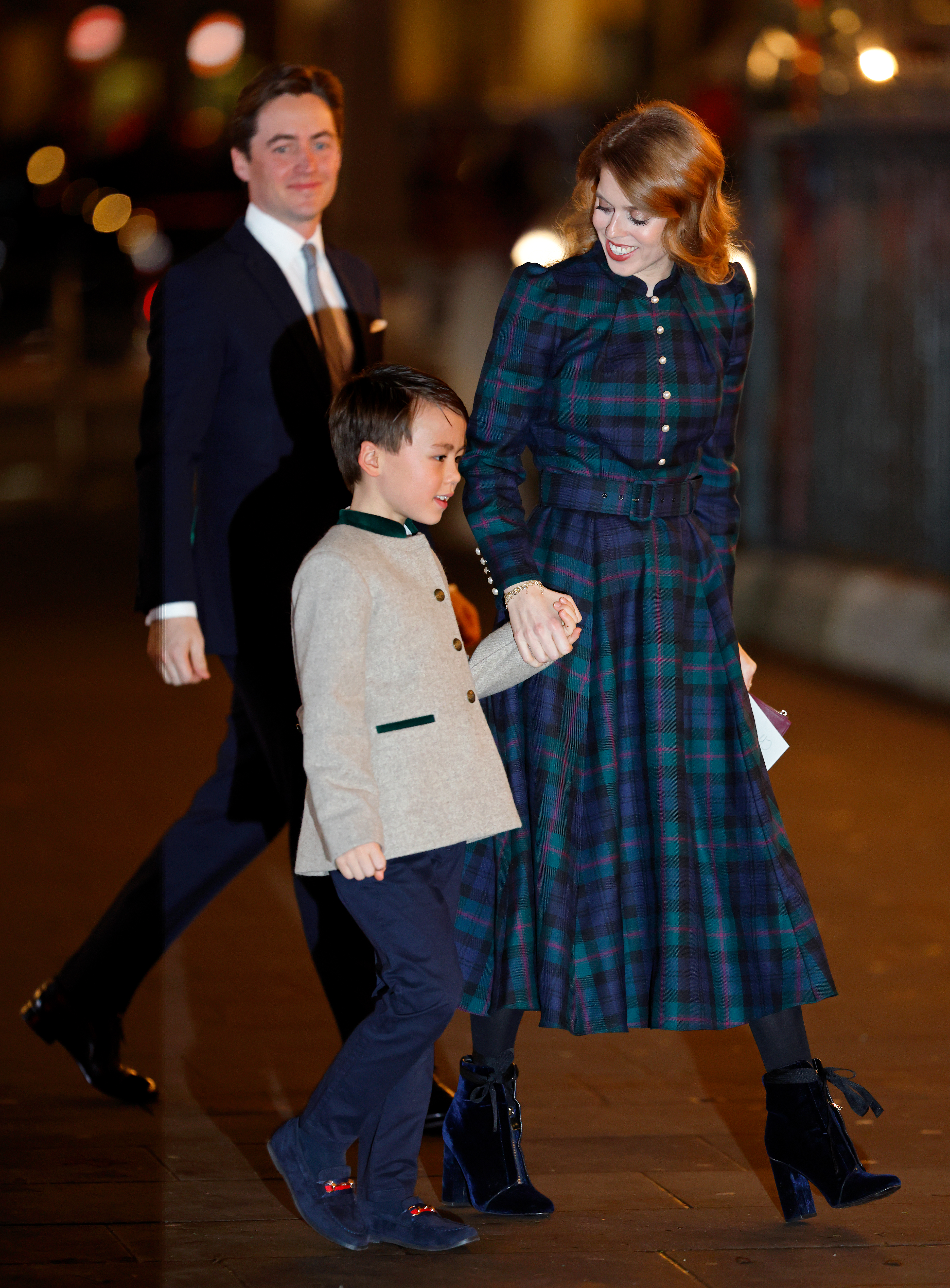 Princess Beatrice wearing a blue plaid dress holding hands with her stepson and Edoardo Mapelli Mozzi walking behind