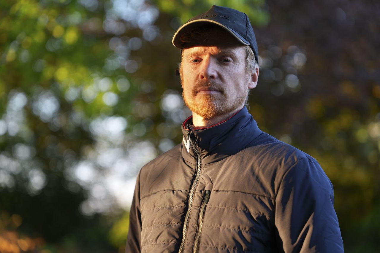 A man at golden hour, illuminated by the sun, natural background