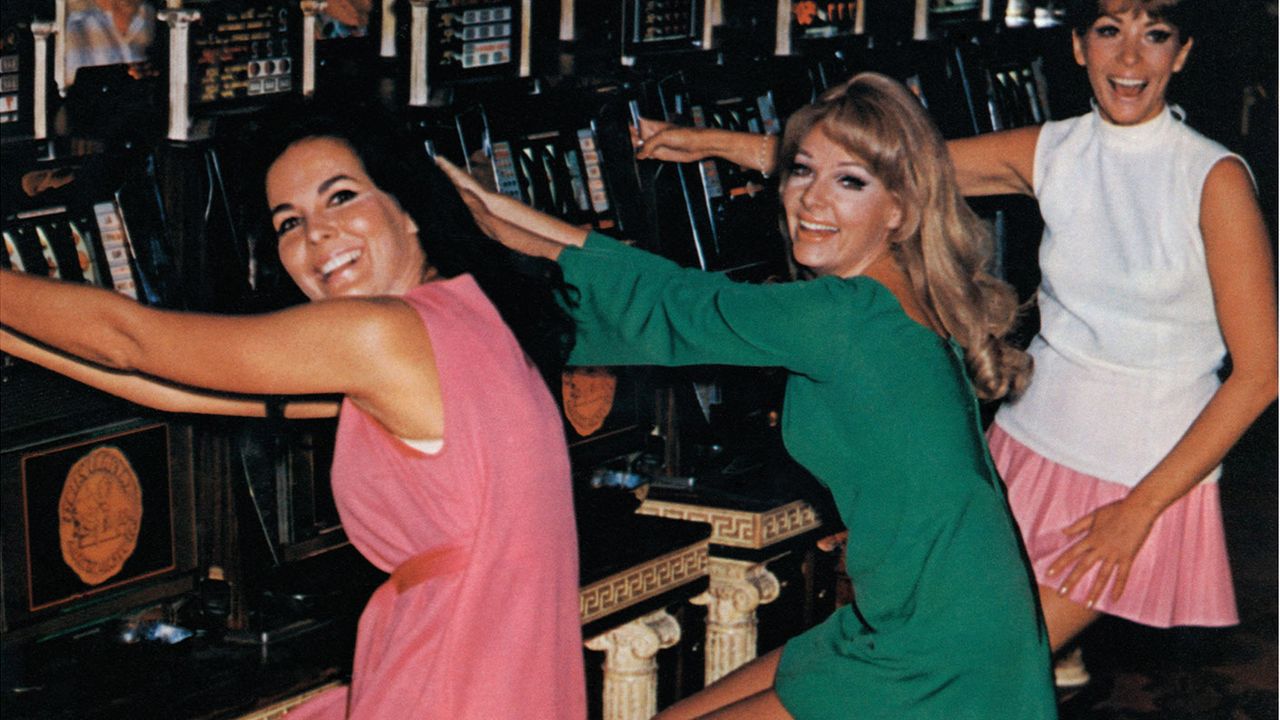 Women playing slot machines in the 1960s