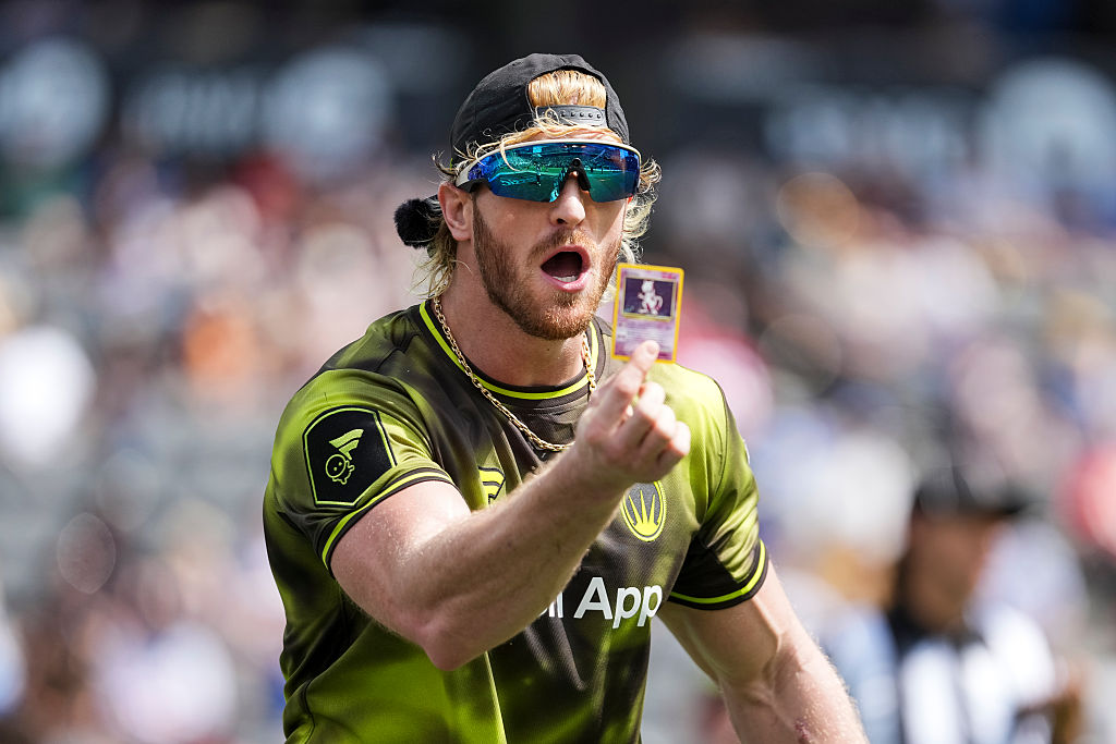 Logan Paul holding a Pokemon card