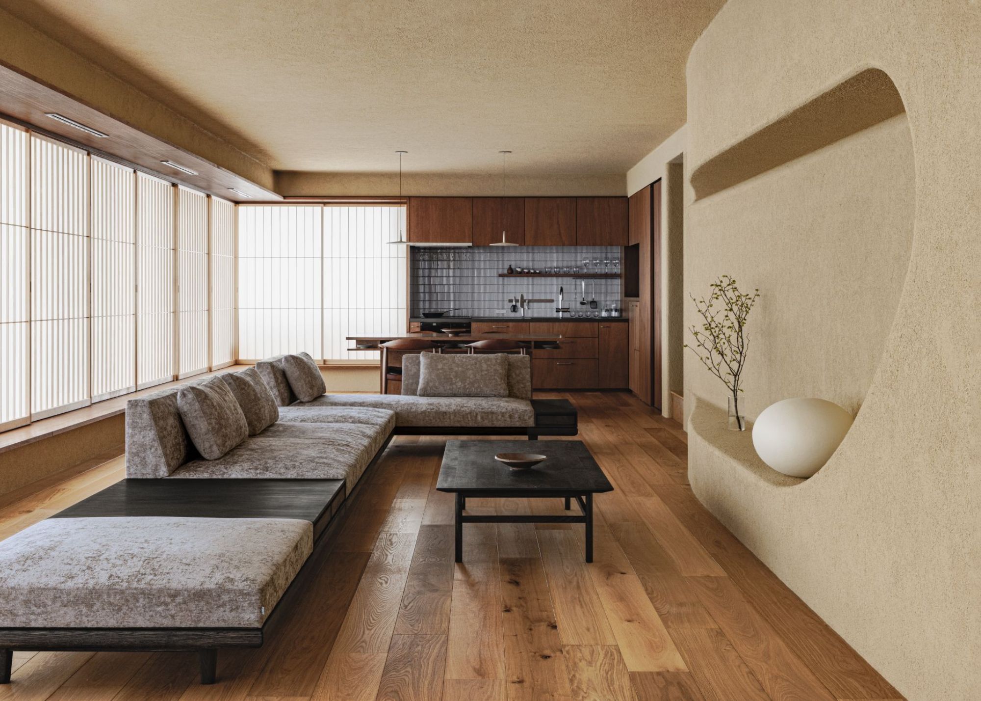 A minimalist Japanese open plan kitchen and living space with shoji screens all along one half of the wall and a corner next to the kitchen, with a low-profile sofa and coffee table with wood flooring