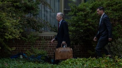 John Bolton leaves his home after being indicted