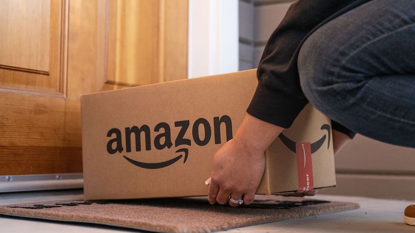 Person placing an Amazon box on a doorstep