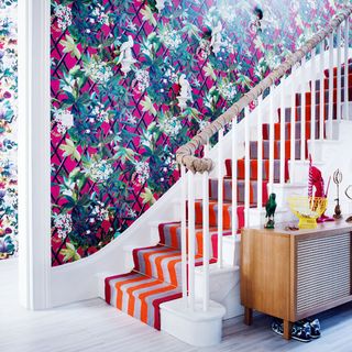 hallway with floral wallpaper and staircase