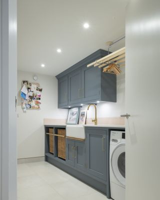 blue utility room with belfast sink and washing machine