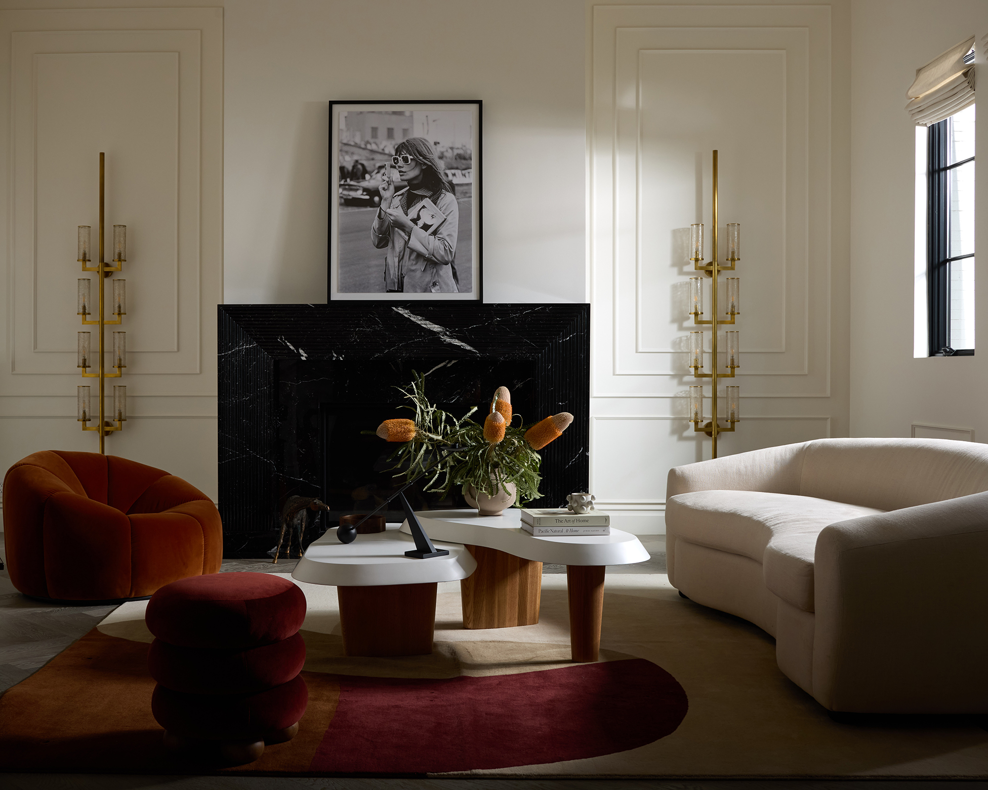 living room with curved sofa and red rug