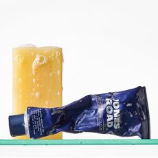 A picture of body products on a shower shelf