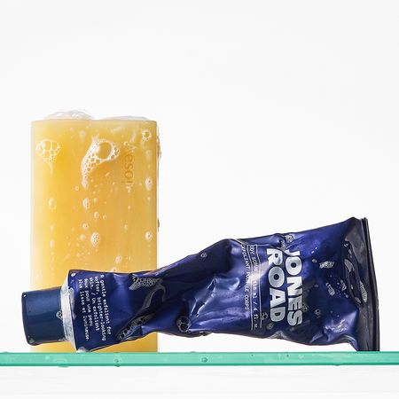 A picture of body products on a shower shelf