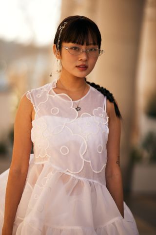 woman in a white dress with dark braid