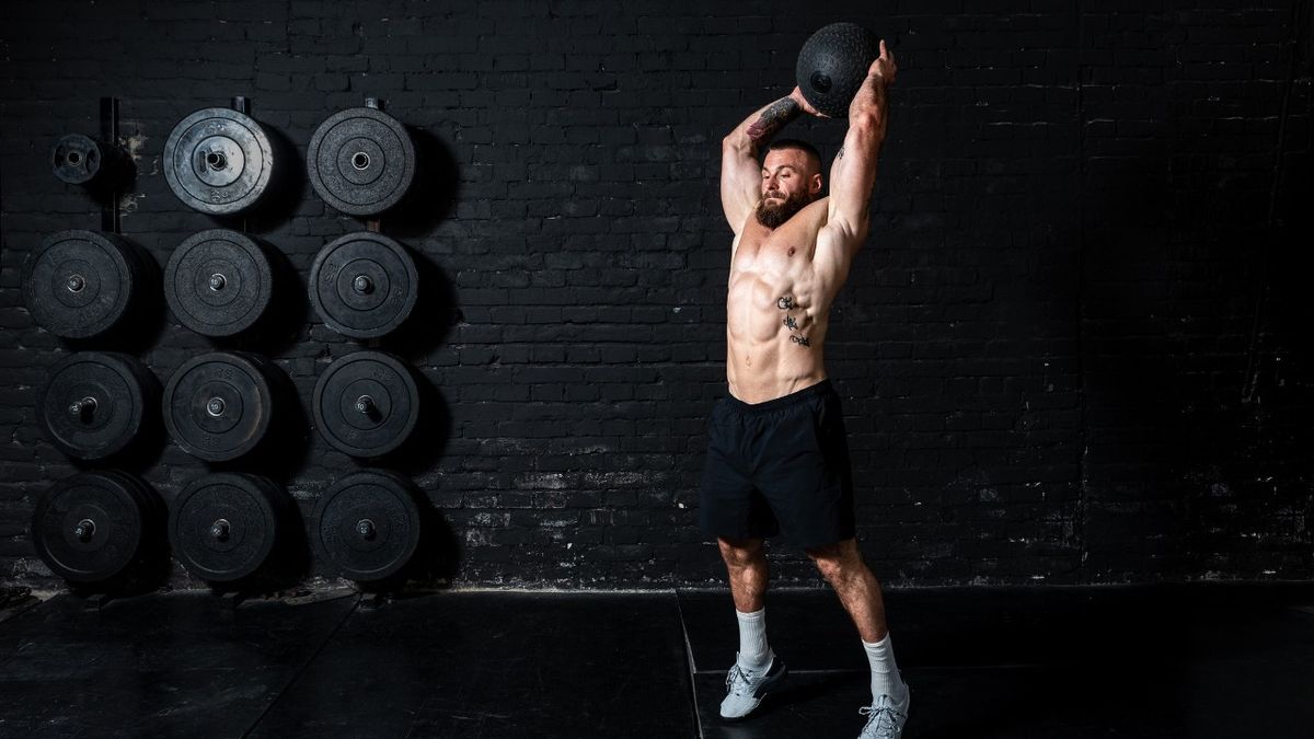 Man about to slam medicine ball into gym floor