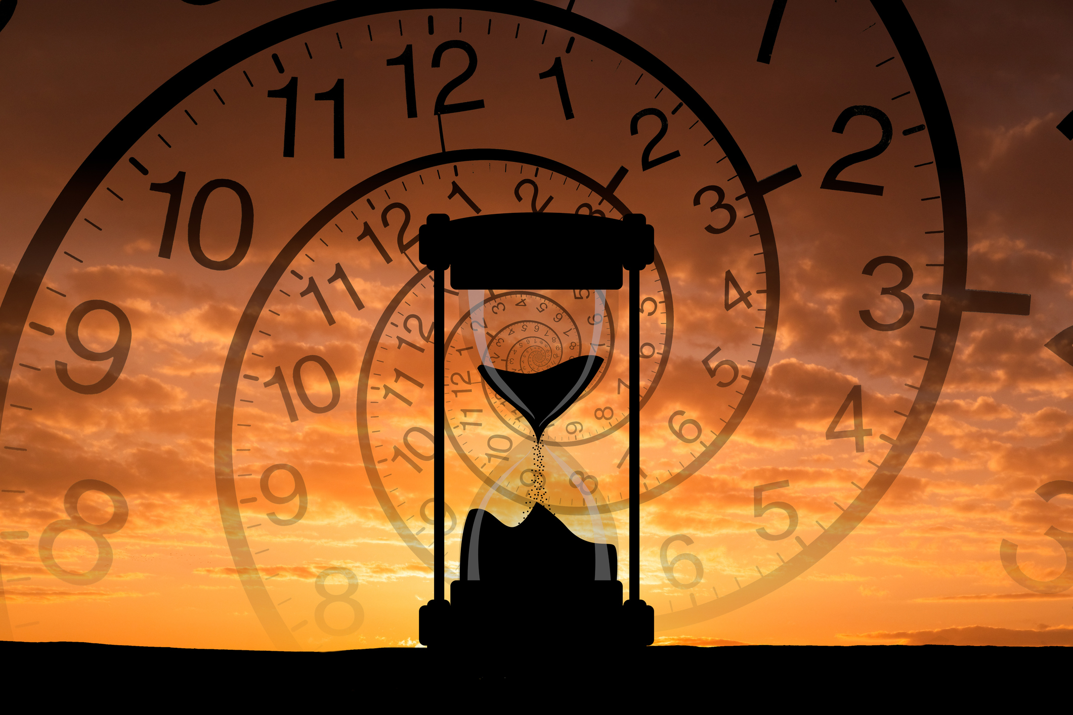 Hourglass with sunset in the background