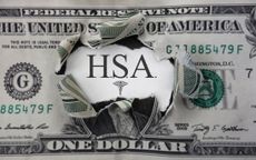 Torn dollar with HSA ( Health Savings Account ) paper message