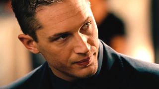 Tom Hardy tilts his head to the side while sharply dressed in This Means War.