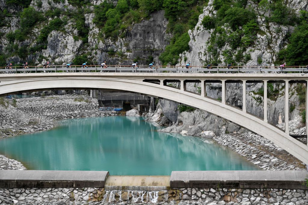 MONTE ZONCOLAN ITALY MAY 22 The Peloton passing through Ravedis Bridge in Maniago Village 283m during the 104th Giro dItalia 2021 Stage 14 a 205km stage from Cittadella to Monte Zoncolan 1730m Landscape UCIworldtour girodiitalia Giro on May 22 2021 in Monte Zoncolan Italy Photo by Tim de WaeleGetty Images