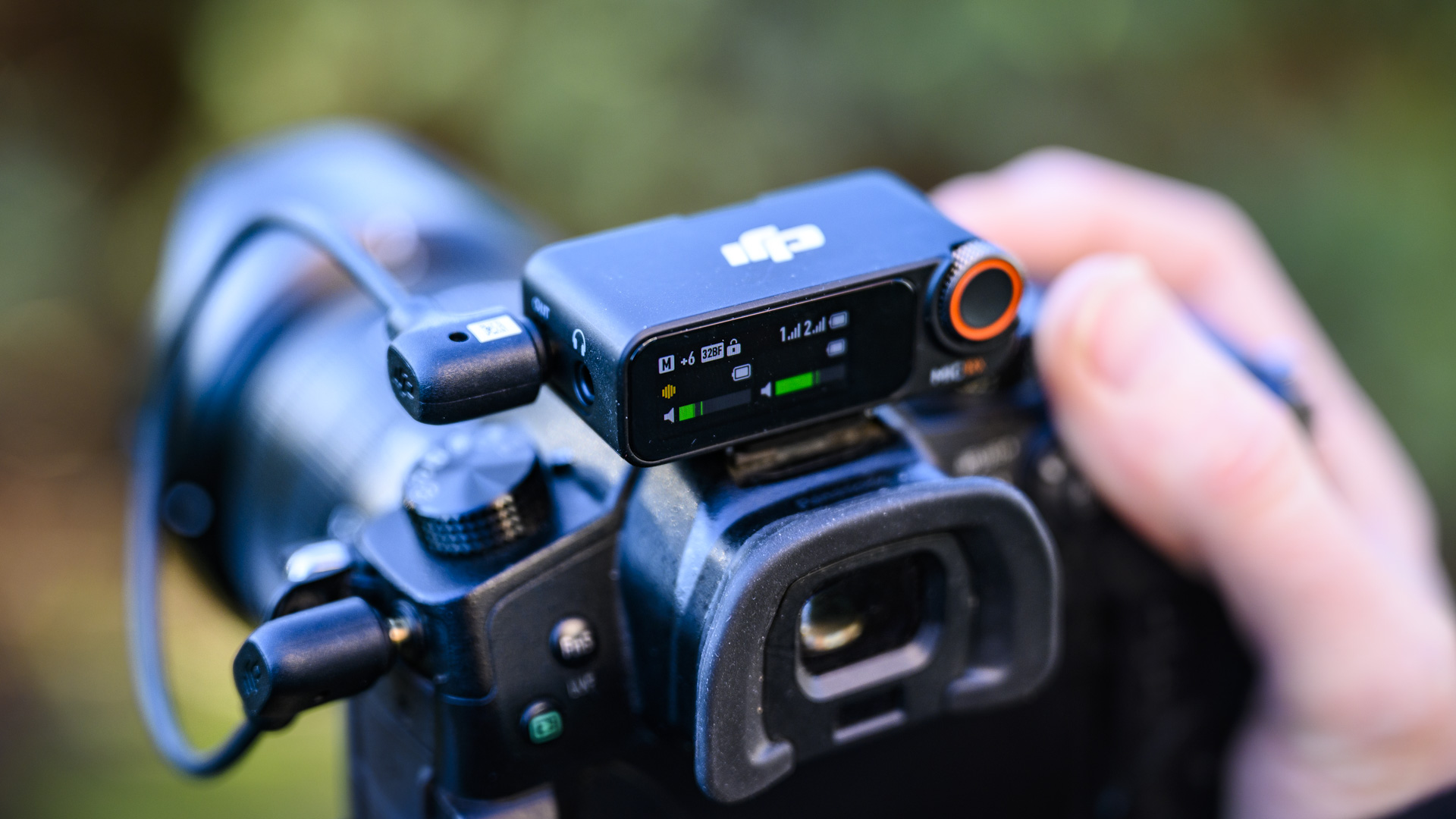 DJI Mic 2 recevier attached to a mirrorless camera