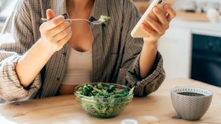 Best foods for hormones: A woman eating a salad