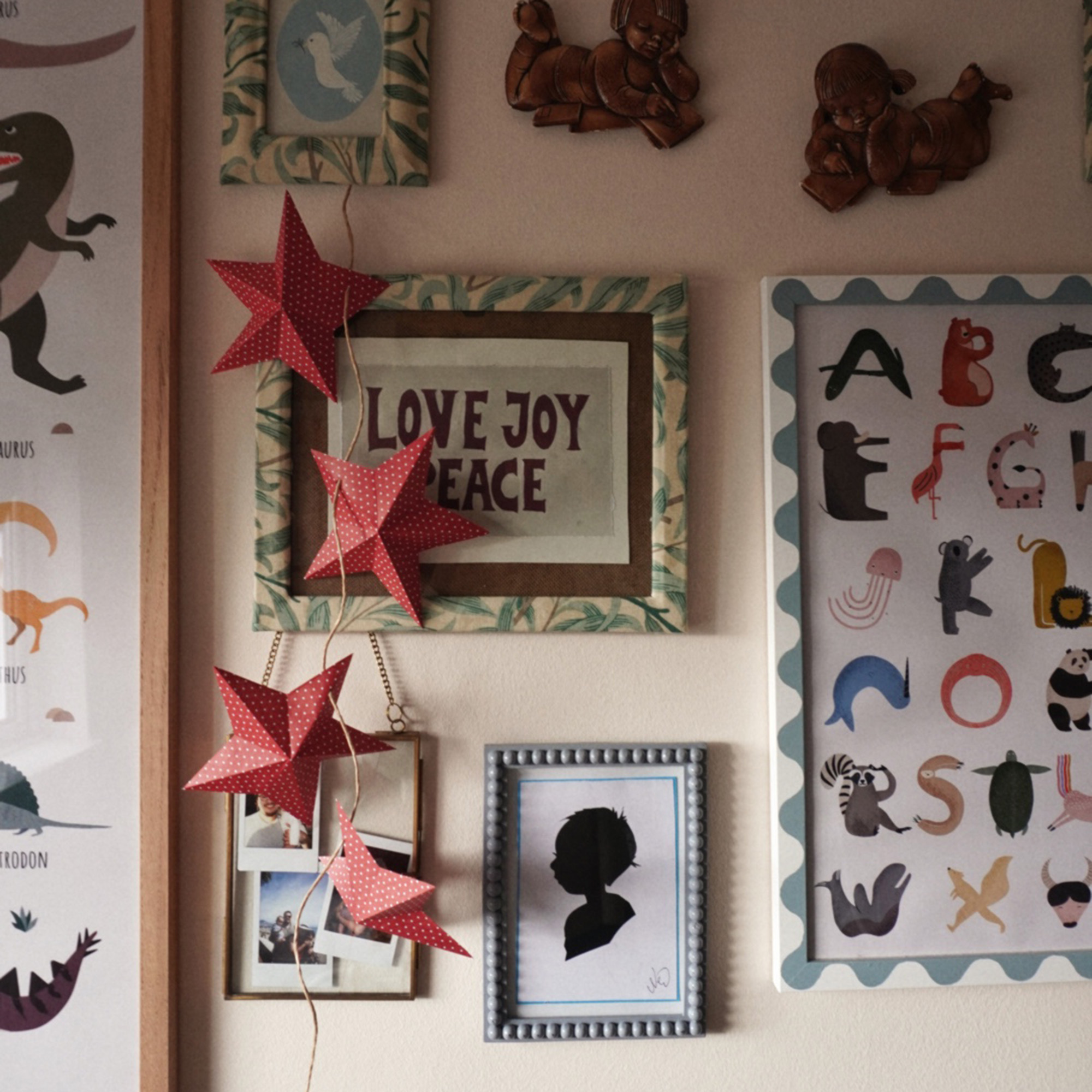 christmas star garland hanging over some wall art