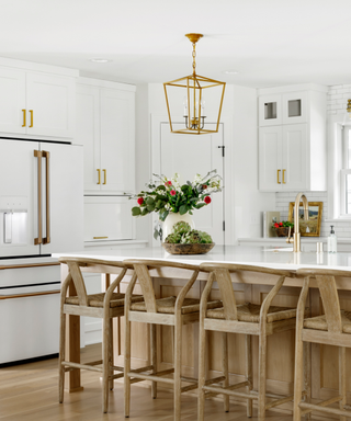 A white kitchen with wooden bar stools