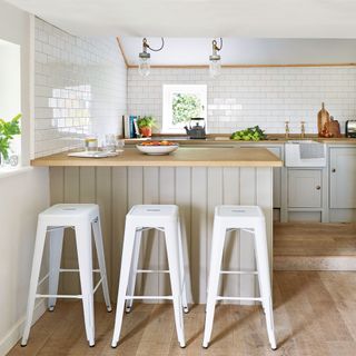 country kitchen with island and white stools