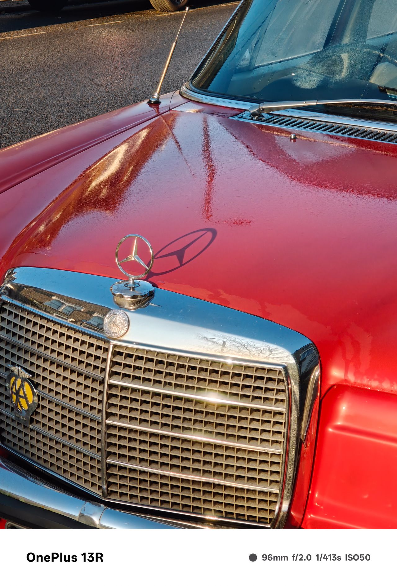 Sun hitting a red vintage Mercedes car