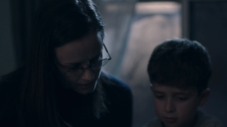 Emily reading with her son Oliver in The Handmaid's Tale Season 3