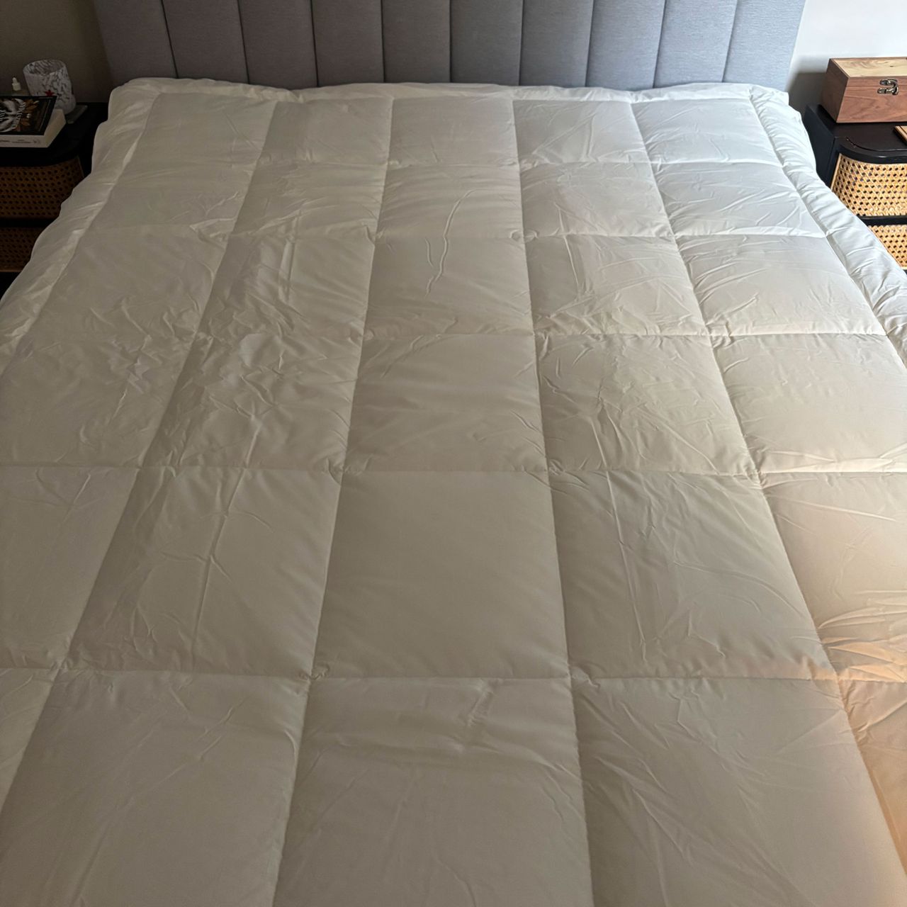 Mattress topper on a mattress on a grey bed