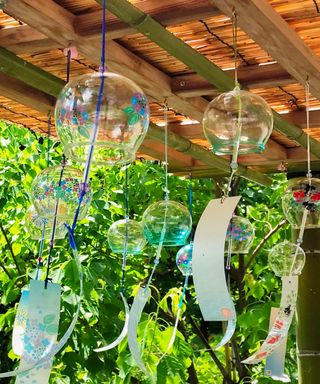 Glass bells hanging in a garden