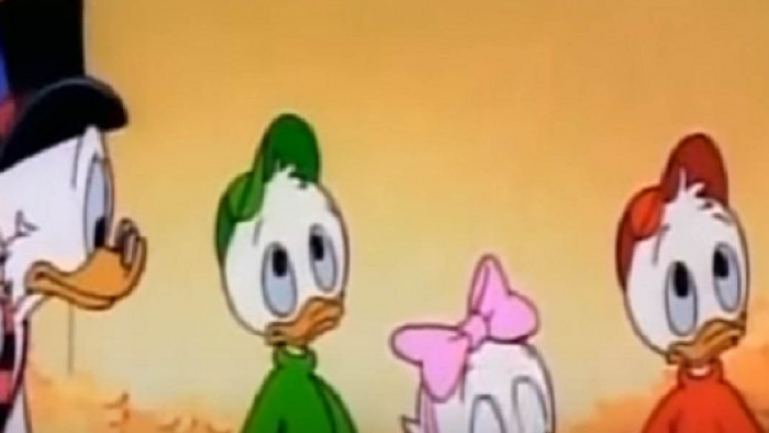 The ducks of Ducktales standing in front of an orange background