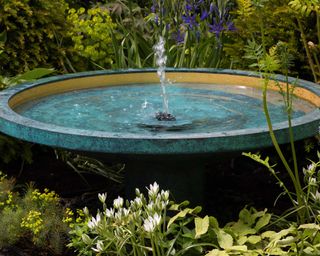blue water fountain in garden