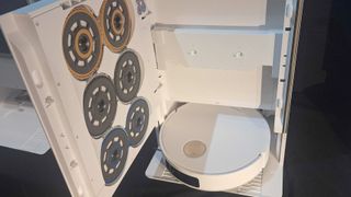 Photo showing the Dreame Matrix10 Ultra's dock with the door open, revealing three sets of different mop pads