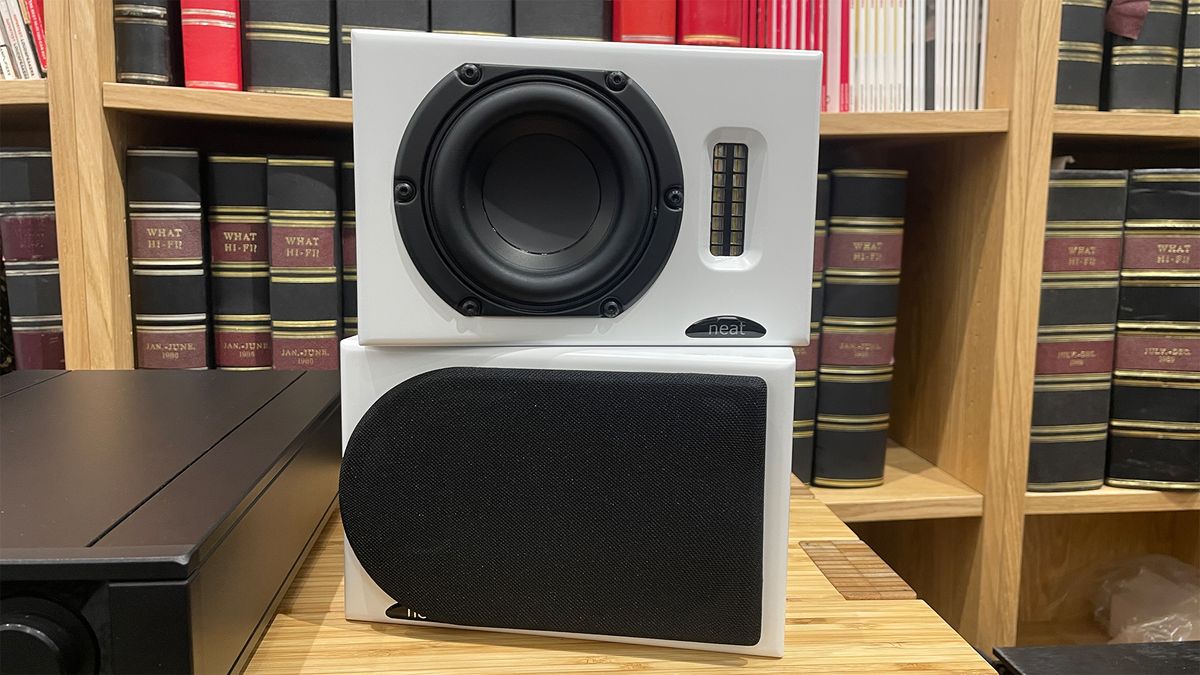 Neat Iota II speakers, with one with black grille on and one off showing the drivers