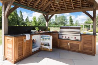 an outdoor kitchen with iroko wood cabinetry
