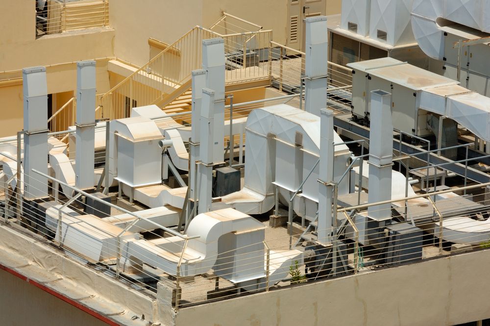 An air conditioning system sits on the rooftop of a building.