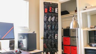 A wide shot of the over-the-door shoe hanger used to store gamepads in a home office