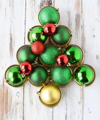 A Christmas wreath made from mason jar lids and bauble decor