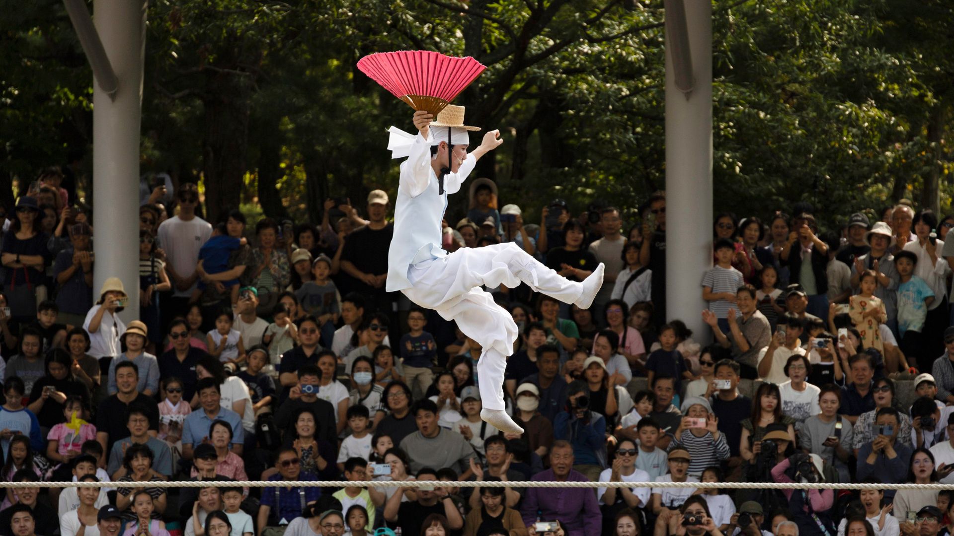 
                                A tightrope walker performs during the Chuseok holiday at Namsan Hanok Village in Seoul, South Korea
                            