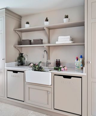A beige utility room with laundry bins