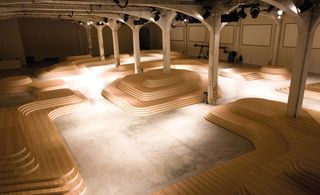 S/S 2009 menswear: A series of undulating timber seating islands demarcated the show space. The modular seating units were also seen later in the year for the A/W 2009 menswear show