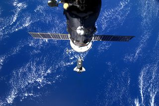 Space shuttle Discovery is seen pulling up to the International Space Station on Feb. 26, 2010 during docking day for its final space mission STS-133. Italian astroanut Paolo Nespoli took this photo from inside the station. A Russian spacecraft is visible