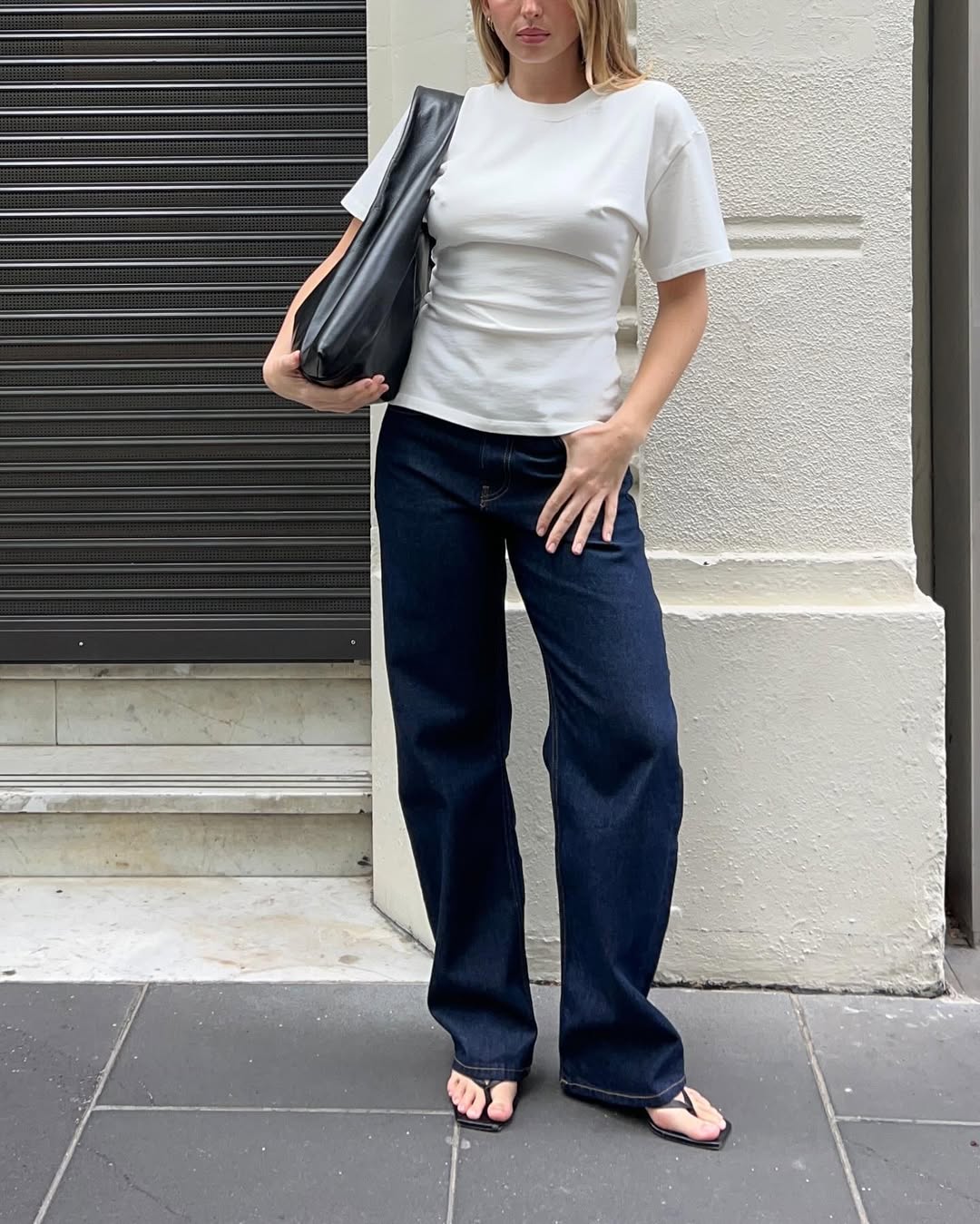 Woman wearing dark wash bootcut jeans fall 2025.