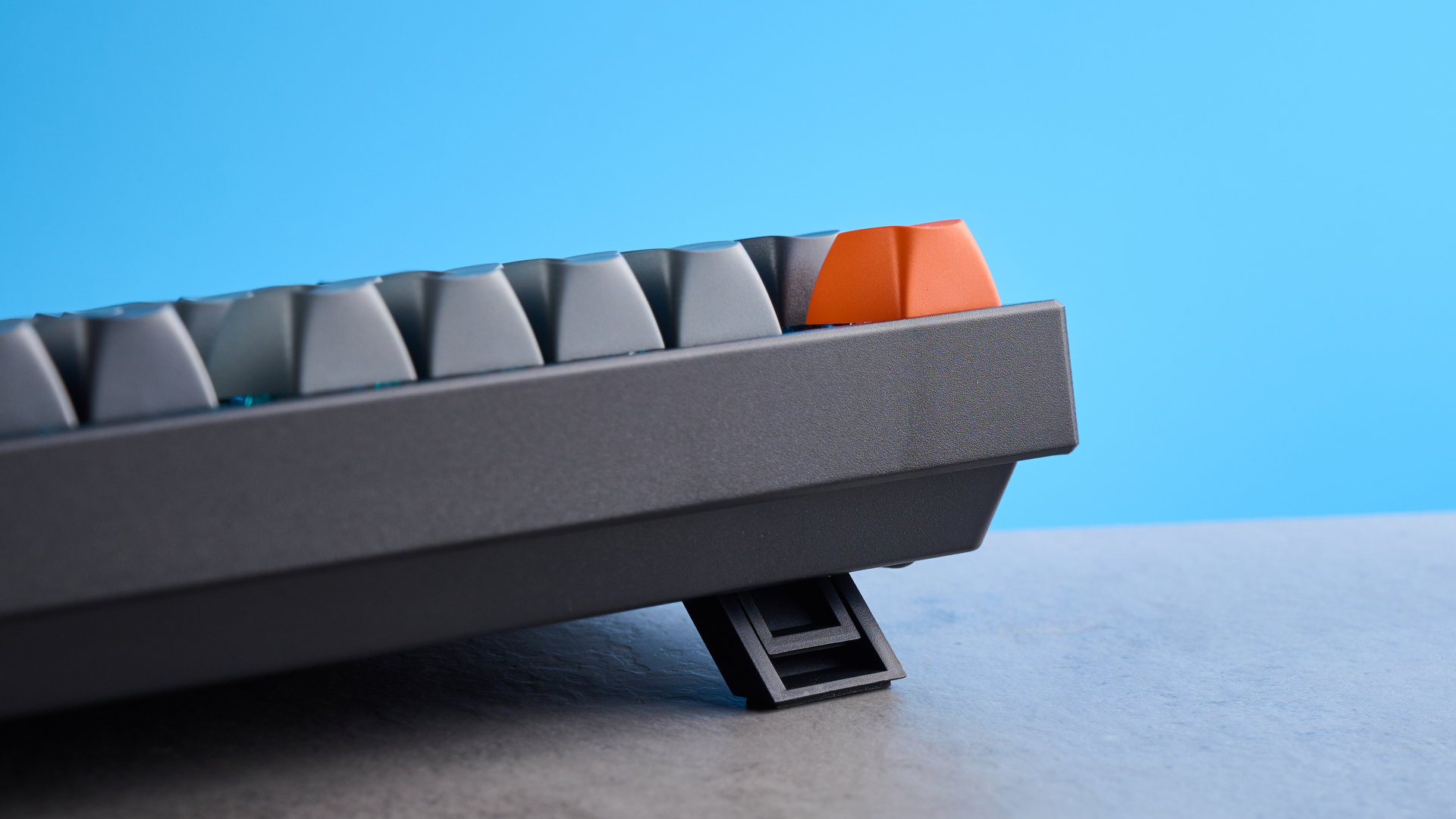 Keychron K8 Max mechanical keyboard in gray photographed on a blue background