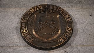 Closeup of the seal on the United States Department of the Treasury building in Washington DC, USA.