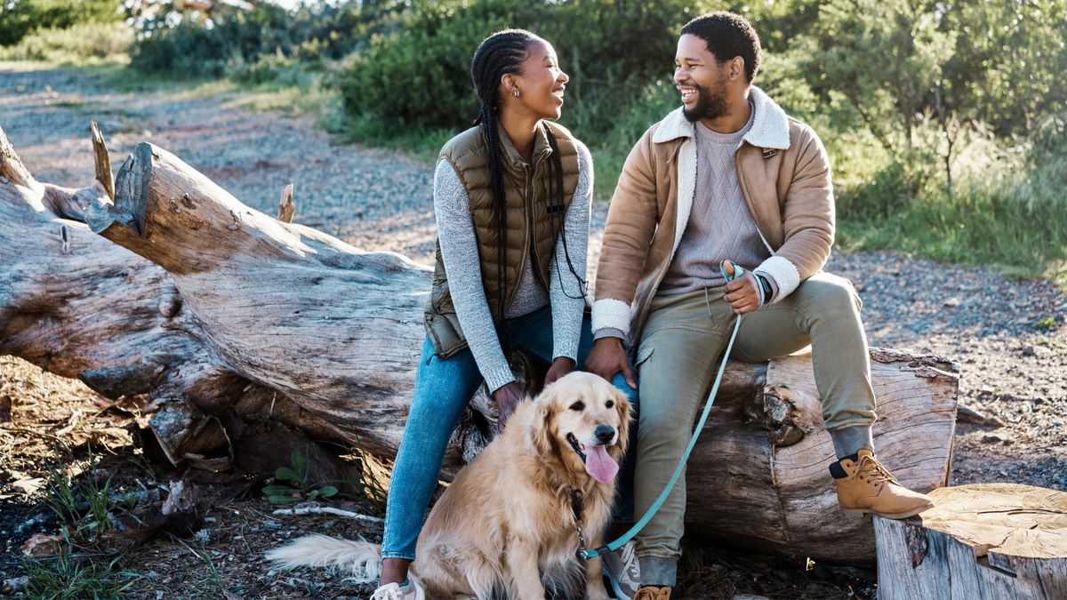 Couple hiking with their dog