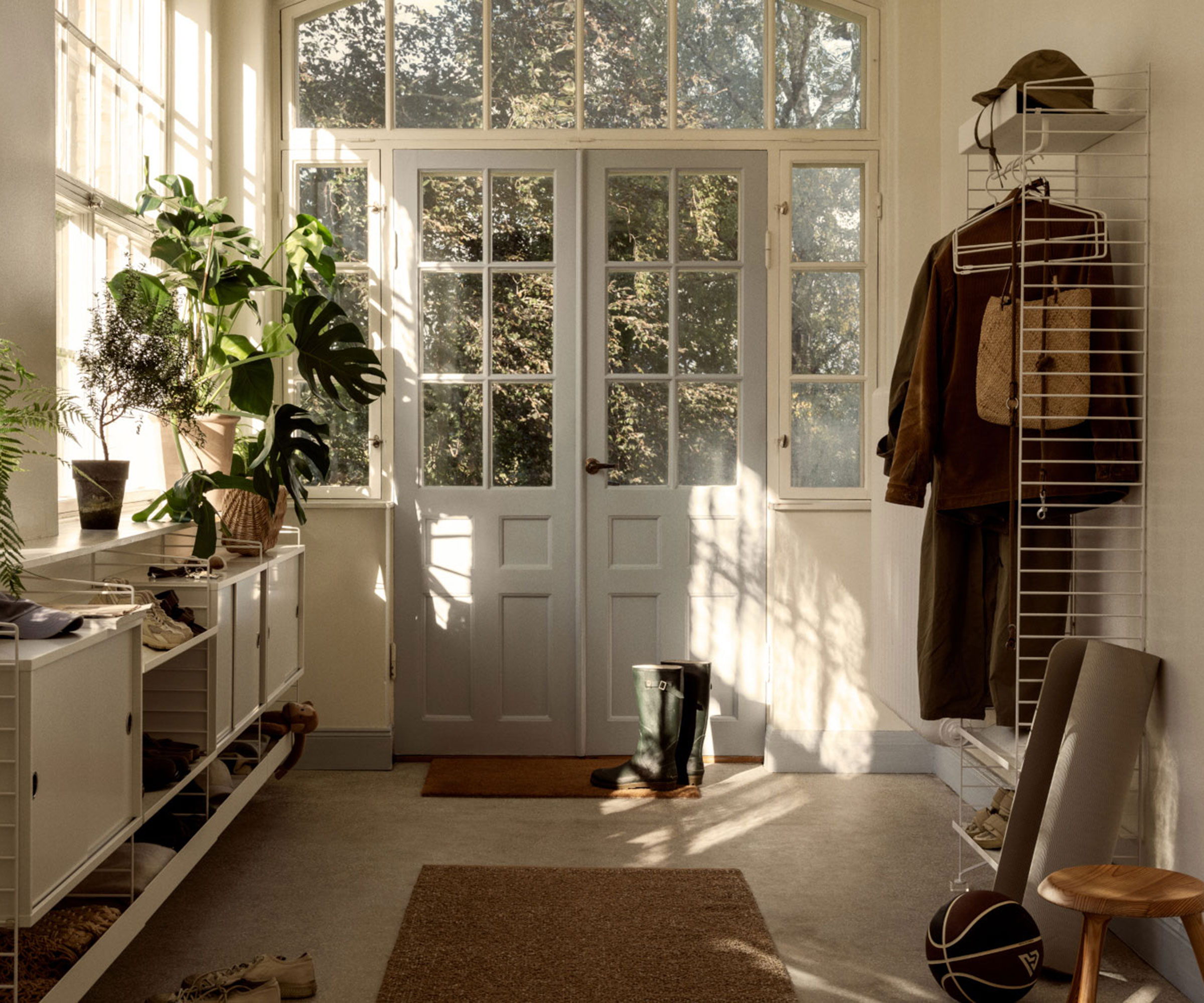 entrance hallway with sideboard and partially glazed wooden doors