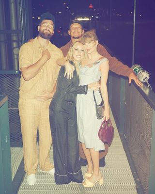 Brittany Mahomes hugs Taylor Swift while Travis Kelce and Patrick Mahomes stand behind them.