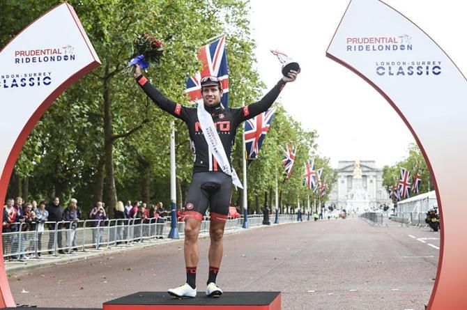 Adam Blythe team NFTO wins the race and stands on the podium in front of Buckingham palace along the Mall.