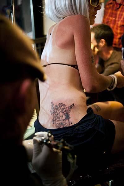 Women's winner Heather Irmiger gets inked at the post-race party.
