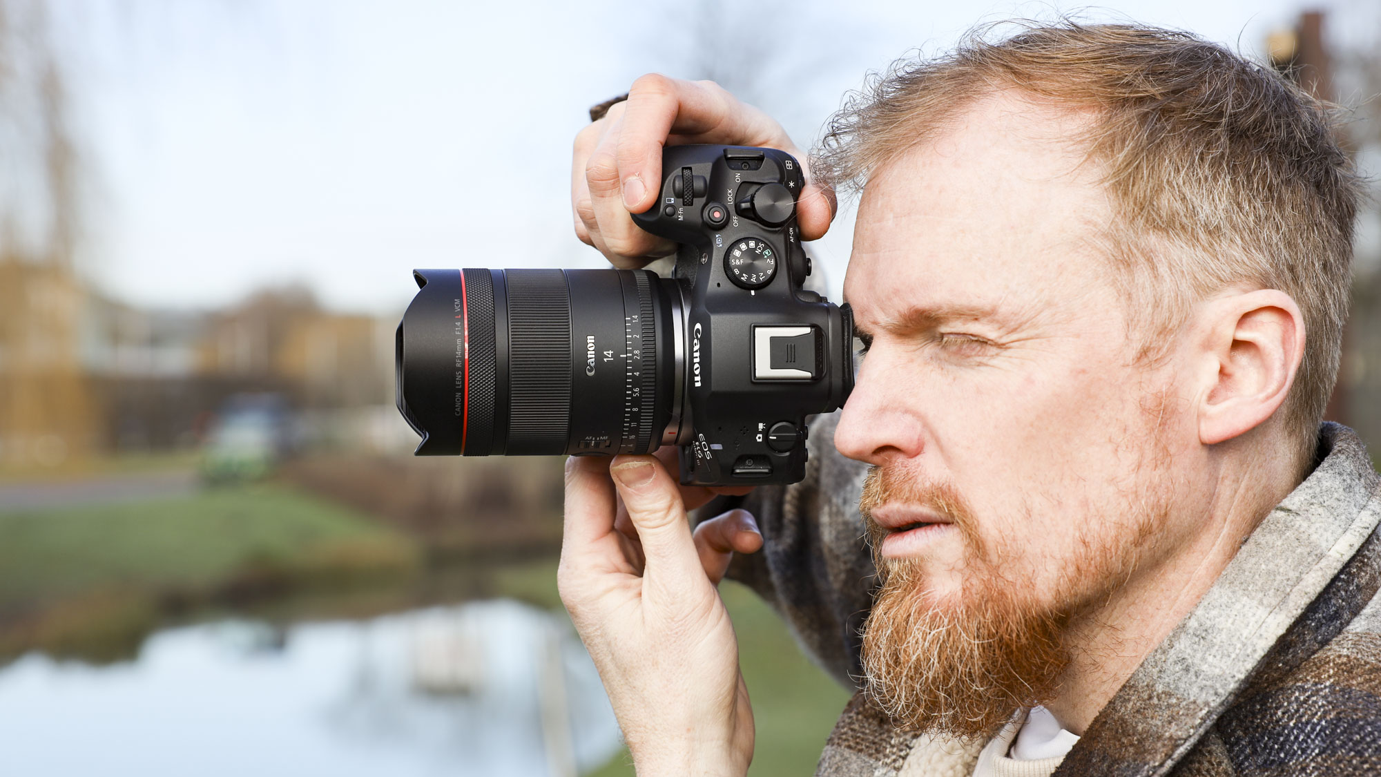 Canon RF 14mm F1.4L VCM lens in photographer Tim Coleman's hands, attached to an EOS R5 mark II