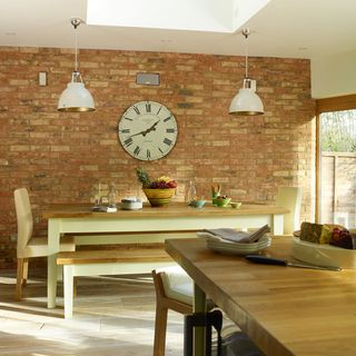 brick wall with wall clock and wooden flooring