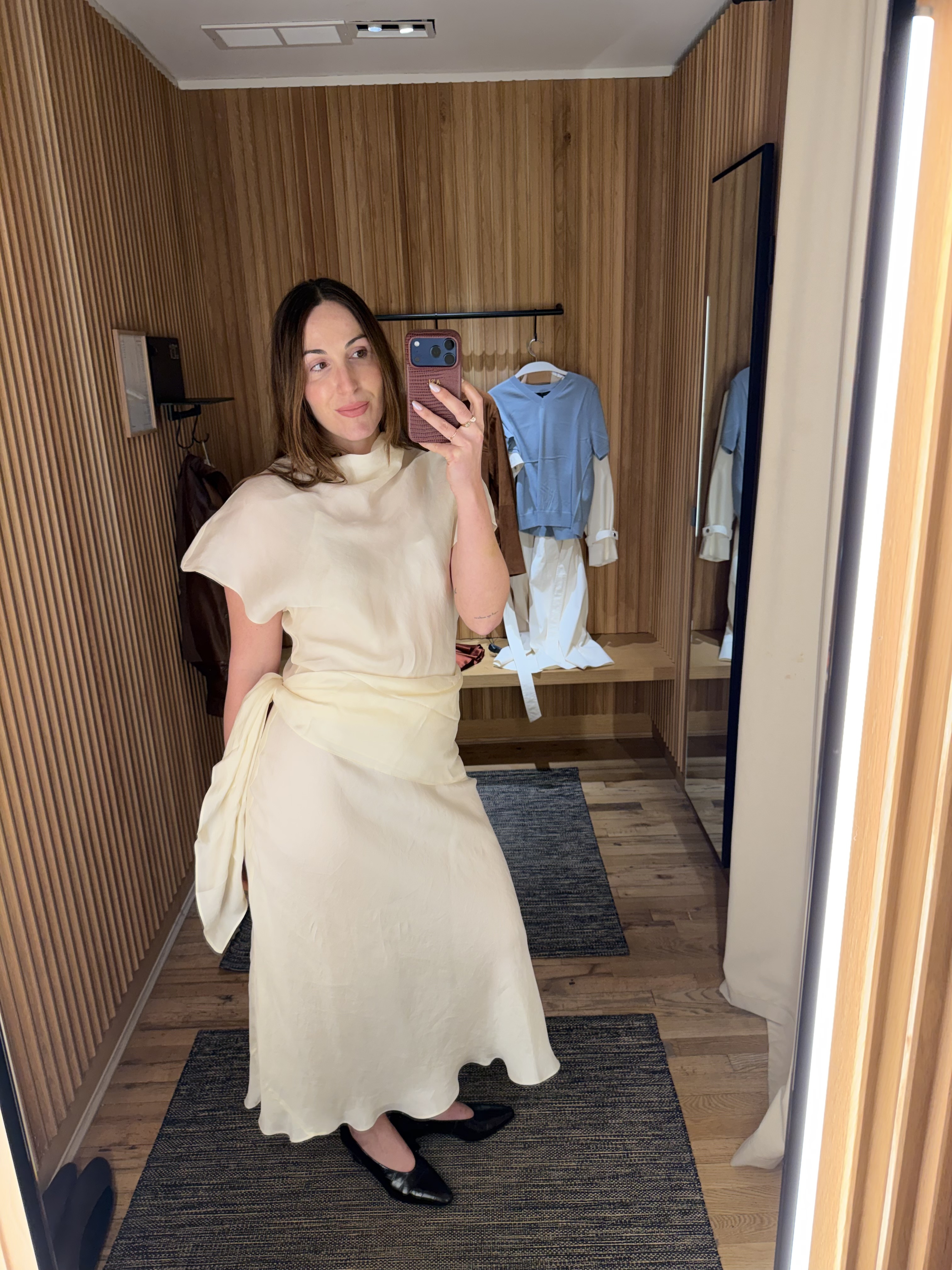 senior fashion editor Anna LaPlaca wearing Mango Selection pieces inside a store dressing room